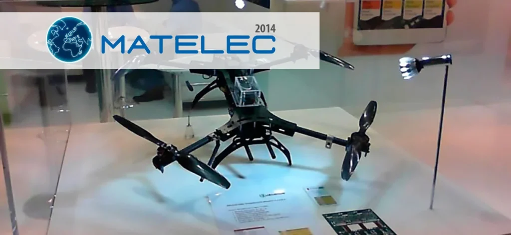Display of a quadcopter drone under bright lights at the MATELEC 2014 exhibition, showcasing cutting-edge electronic innovations.