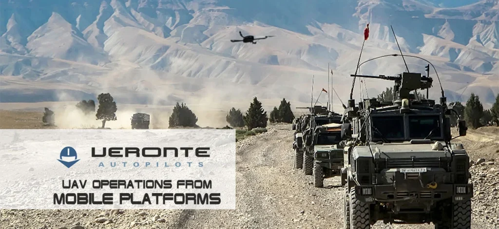 Military vehicles in a convoy with a drone overhead in a snowy mountain landscape.