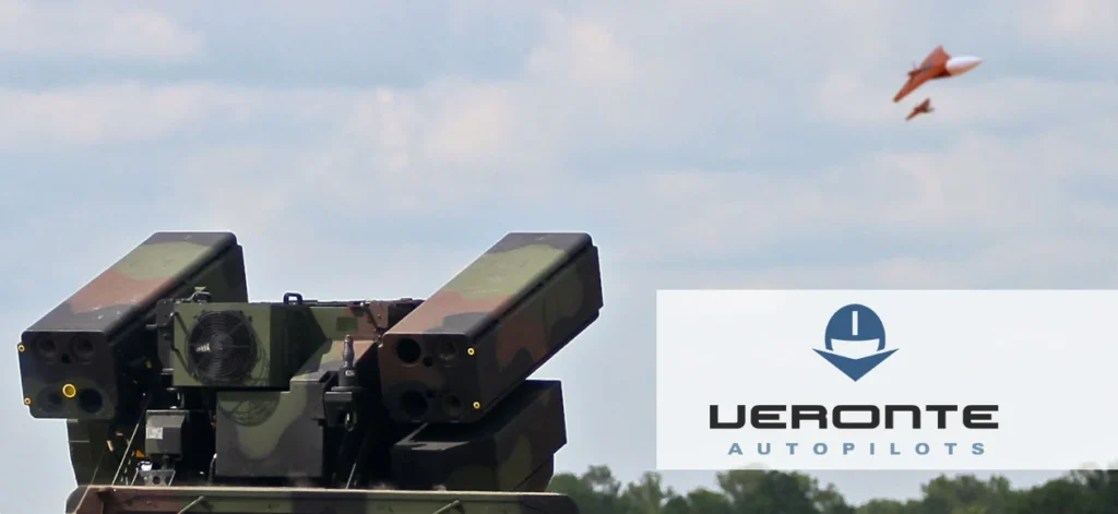 Autonomous target drone flying near a military defense system, demonstrating advanced unmanned technology in action.