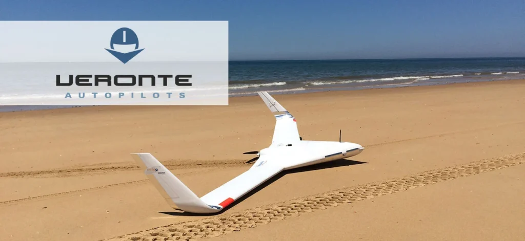 Fixed-wing drone on a sandy beach, highlighting professional UAV training in diverse environments