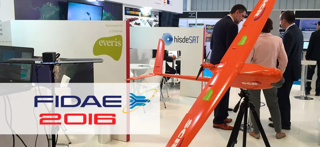 Aerospace FIDAE trade show booth with people examining UAV technology.