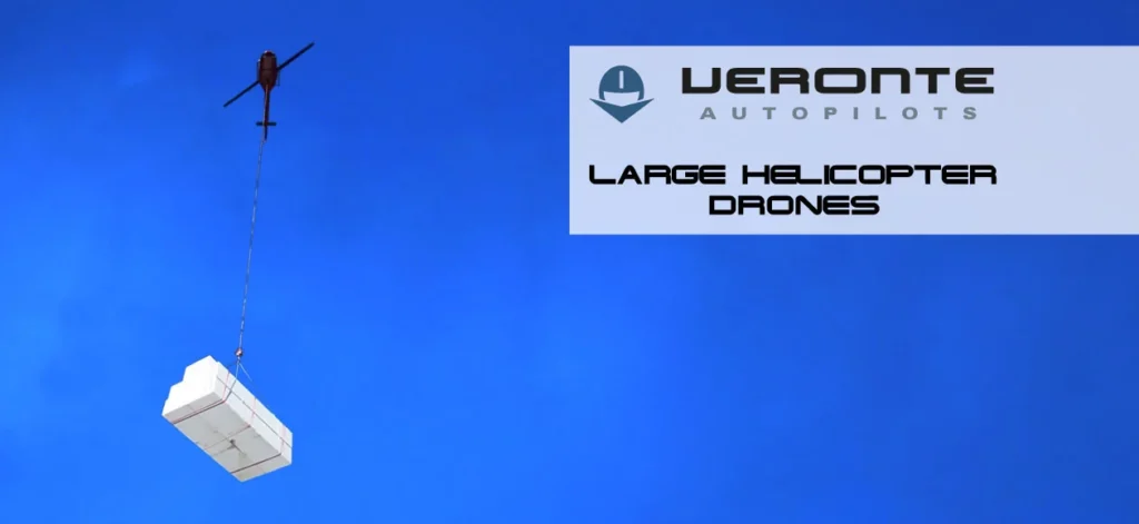 Large helicopter drone carrying a heavy cargo box, with Veronte Autopilots logo and text indicating large helicopter drones, against a clear blue sky background.