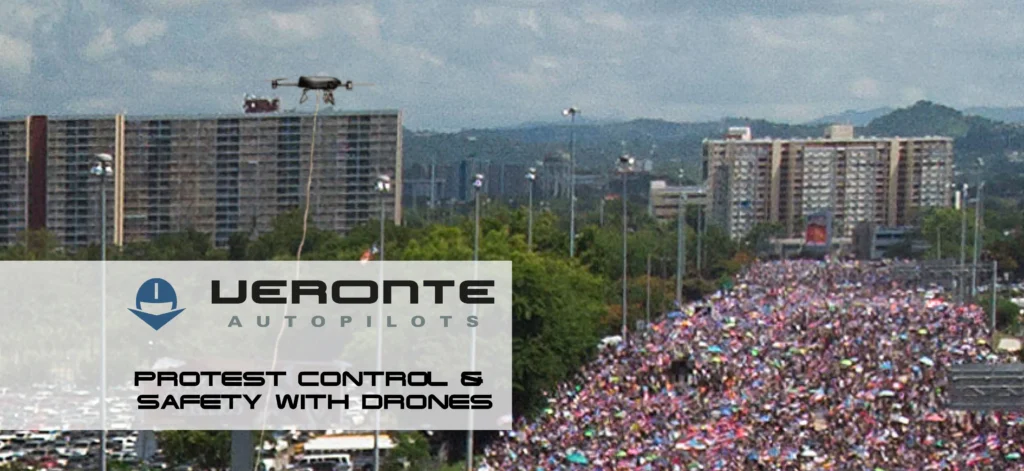 A drone hovers above a massive crowd during a protest, showcasing the use of drone technology by Veronte Autopilots for crowd monitoring and control.