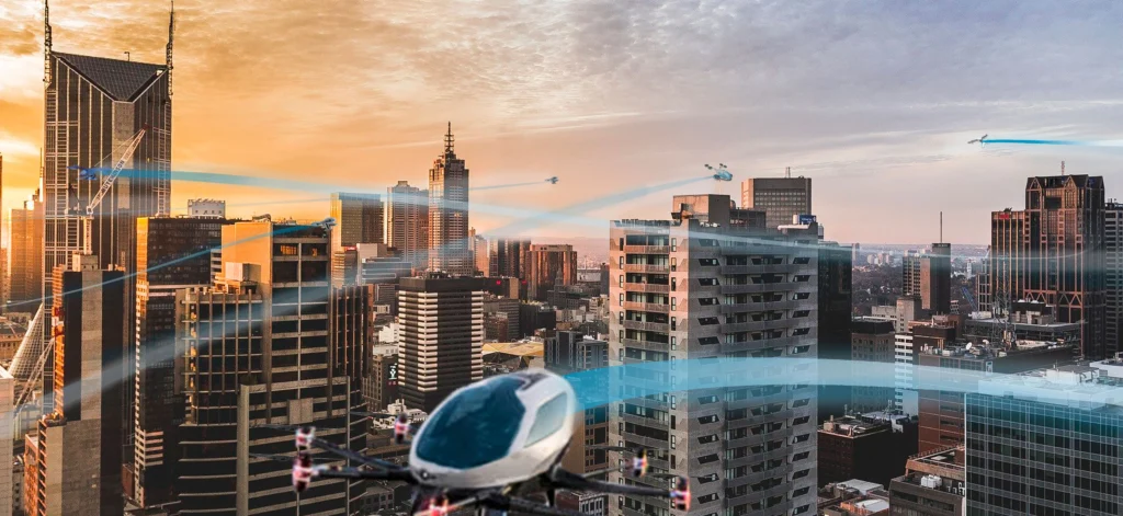 Concept image of eVTOL aircraft flying over a modern city skyline at sunset, illustrating the future of urban air mobility with multiple eVTOL vehicles navigating through the urban airspace.