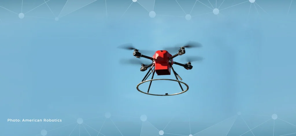 Autonomous red UAV drone flying in clear sky