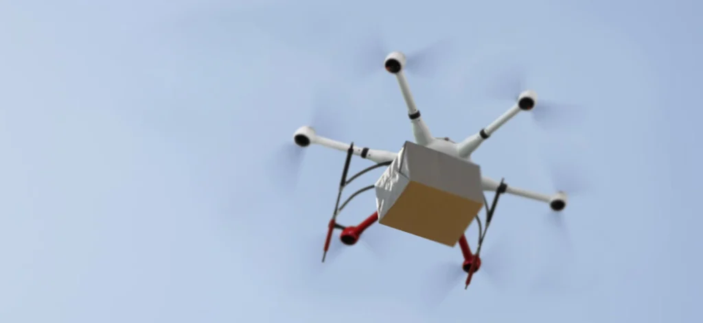 Drone delivering a package in the sky, illustrating UAV logistics efficiency.