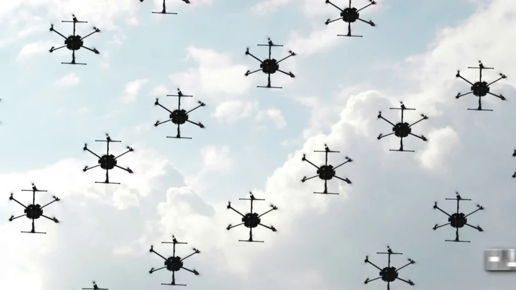 bottom view of several drones flying over a background of blue sky with clouds