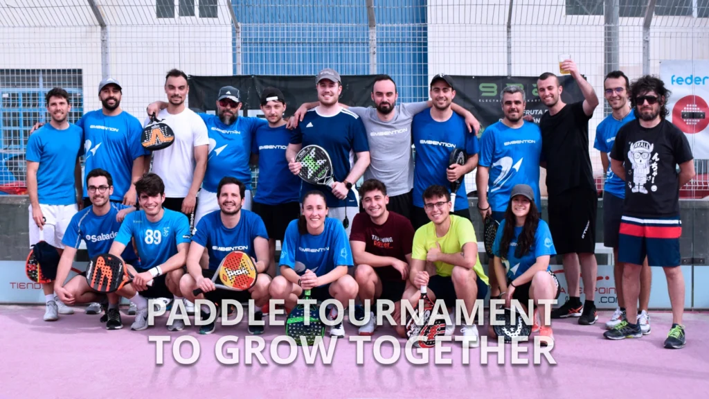 group of Embention employees stand in a paddle tennis court