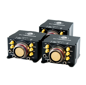 __DRx Three black cube-shaped electronic modules aligned closely together, each featuring a circular central connector and multiple gold-plated ports, labeled for various connections such as 'LOG', 'GNSS', and 'PITOT'.