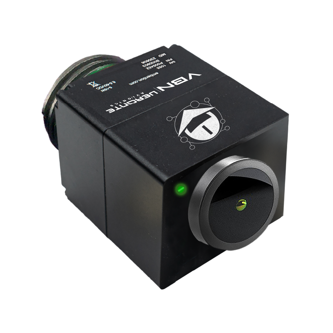 VBN-Portada Compact black electronic device labeled 'VBN Veronte Avionics', featuring a prominent circular green-lit front lens and detailed labeling on the top surface, designed for advanced imaging and navigation.
