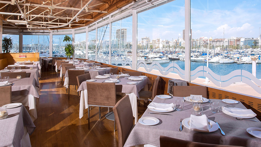 Darsena Elegant restaurant with marina view and neatly set tables.