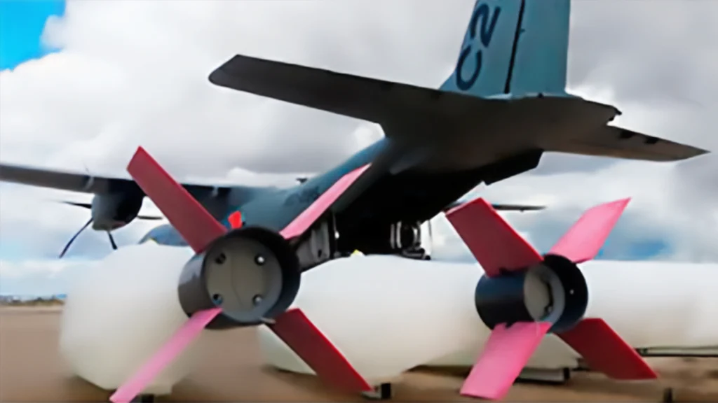 A close-up of a drone equipped with colorful propellers, preparing for aerial firefighting with a water or retardant payload.