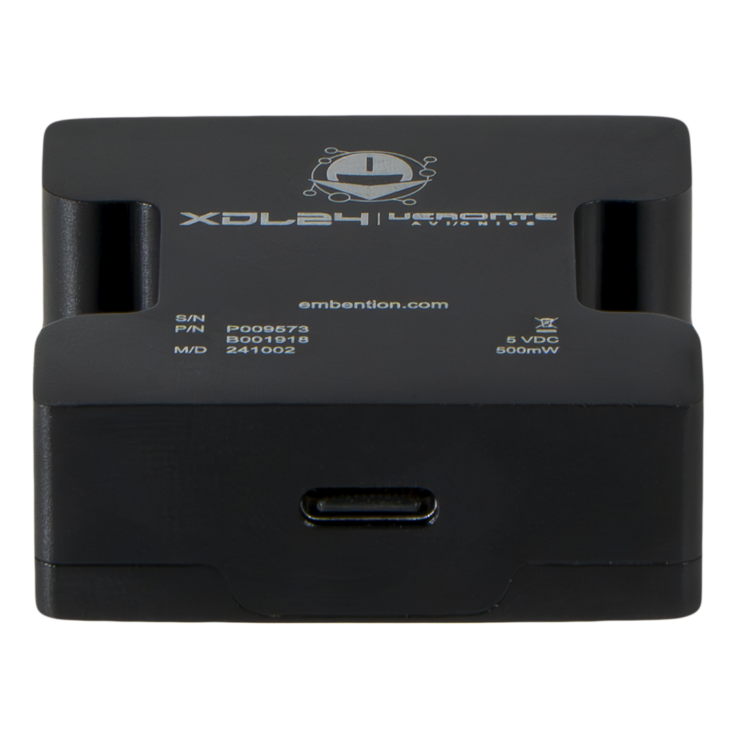 XDL24 - Portada Front view of a black cube-shaped electronic module labeled '1x Veronte Autopilot', featuring multiple gold-plated ports and a large central circular connector, with additional labeling for specifications like power and data connections.